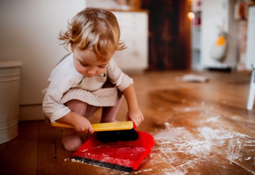 Child Sweeping Up Floor