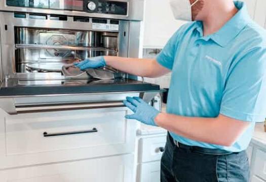Merry Maid Cleaning an oven