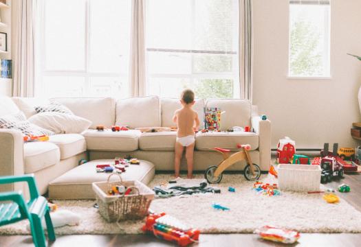 Boy playing with scattered toys everywhere