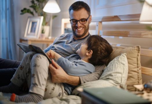 Dad reading bedtime stories to son | Merry Maids