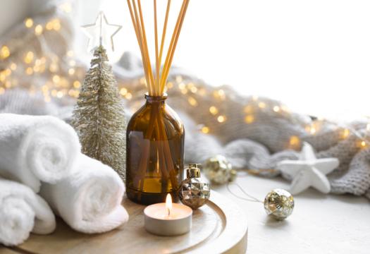 Christmas spa composition with towels, candle and incense sticks | Merry Maids